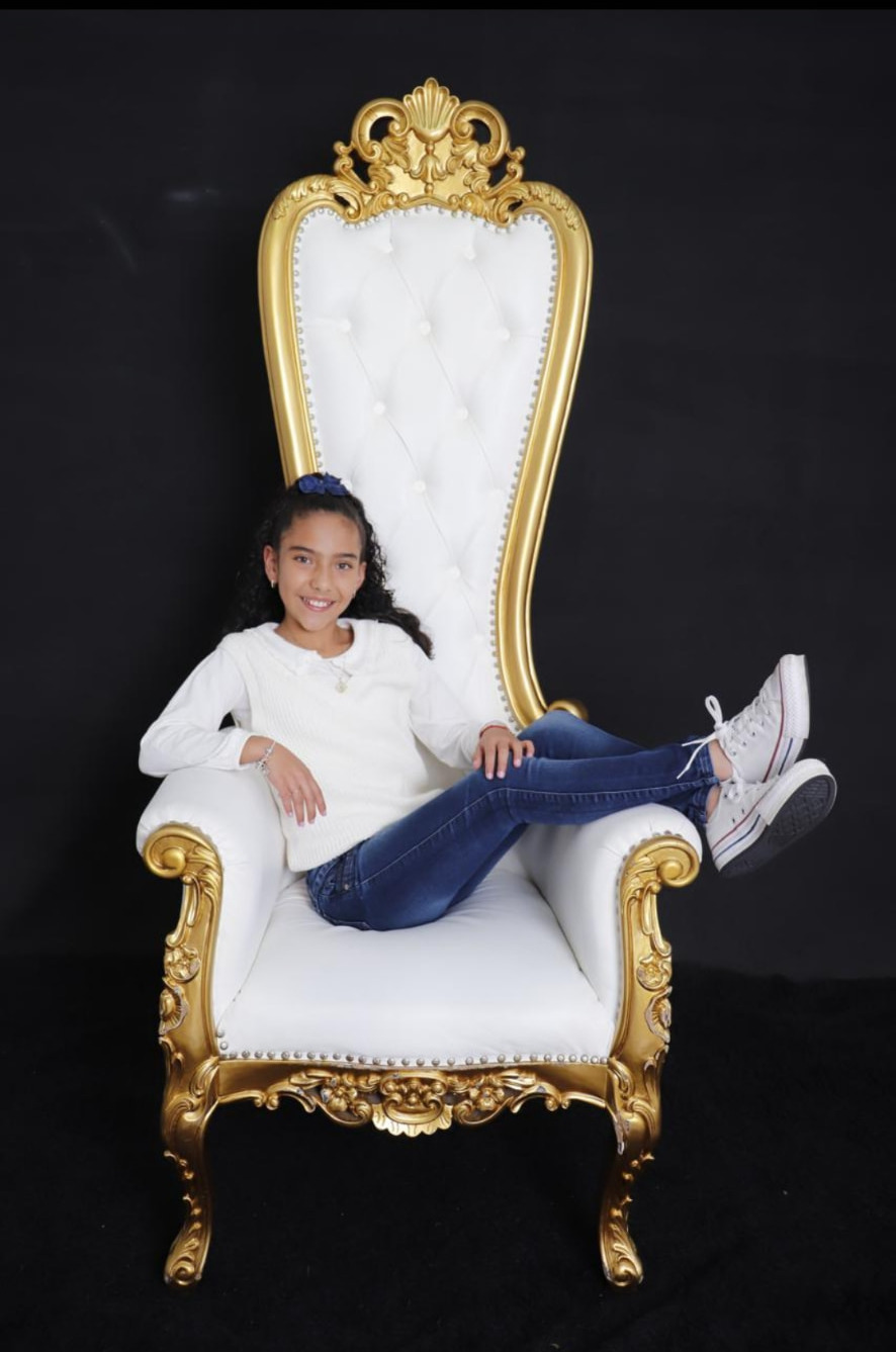 Victoria sentada en una silla dorada